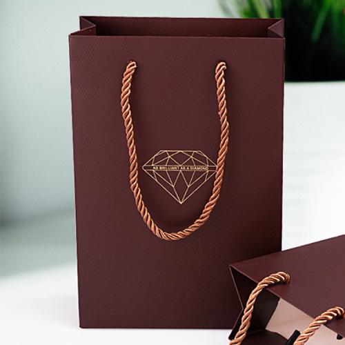 Handmade high quality guarantee gold stamping paper gift packaging bag with custom logo and handles