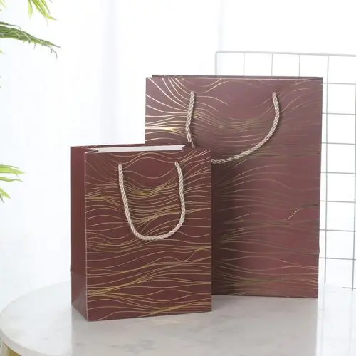 Wholesale Simple Delicate Gold Stamping Printed Paper Gift Packaging Bag With Custom Design Logo Wholesale Simple Delicate Gold Stamping Printed Paper Gift Packaging Bag With Custom Design Logo